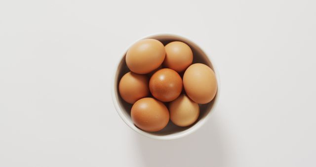 Close up of bowl of brown eggs with copy space on white surface - Download Free Stock Photos Pikwizard.com
