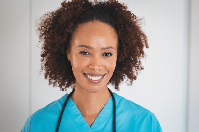 Portrait of happy mixed race female doctor with stetoscope smiling - Download Free Stock Photos Pikwizard.com