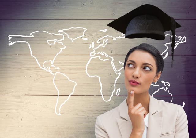 Thoughtful businesswoman with graduation cap and world map on wooden plank background - Download Free Stock Photos Pikwizard.com