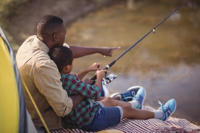 Father and son fishing together in park - Download Free Stock Photos Pikwizard.com