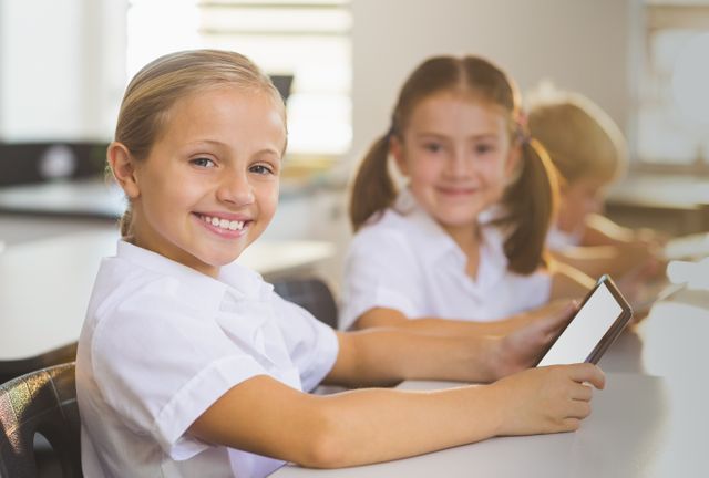 School girls using digital tablet in classroom - Download Free Stock Photos Pikwizard.com