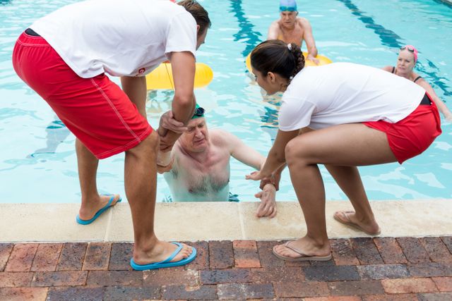 Lifeguards helping unconscious senior man in swimming pool - Download Free Stock Photos Pikwizard.com