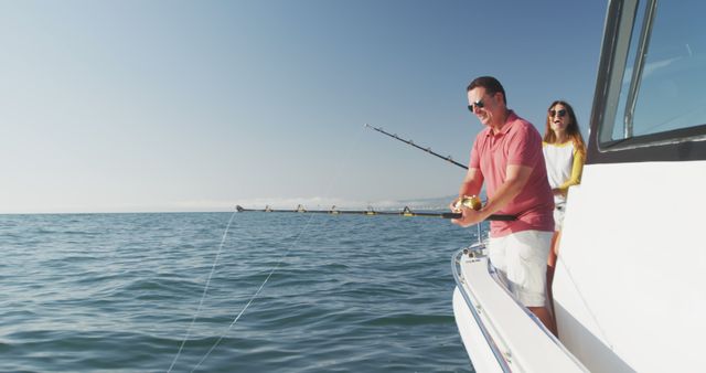 Reels of fishing rods onboard fishing boat on sunny day, with