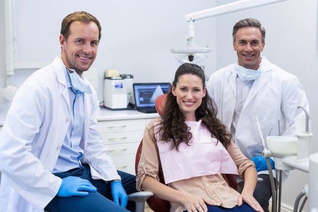 Portrait of smiling dentists and female patient - Download Free Stock Photos Pikwizard.com