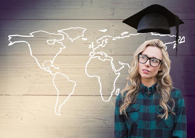 Woman in spectacle and mortarboard above head against world map on wooden background - Download Free Stock Photos Pikwizard.com
