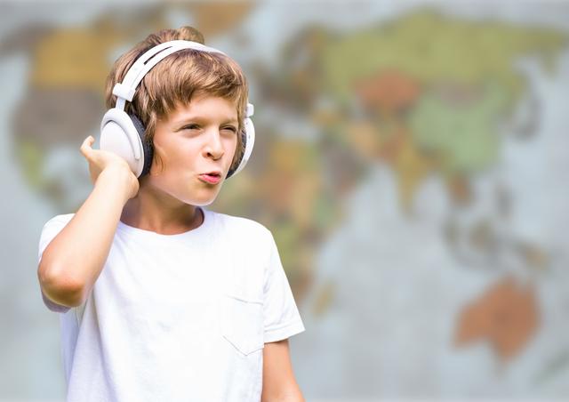 Boy with headphones against blurry map - Download Free Stock Photos Pikwizard.com