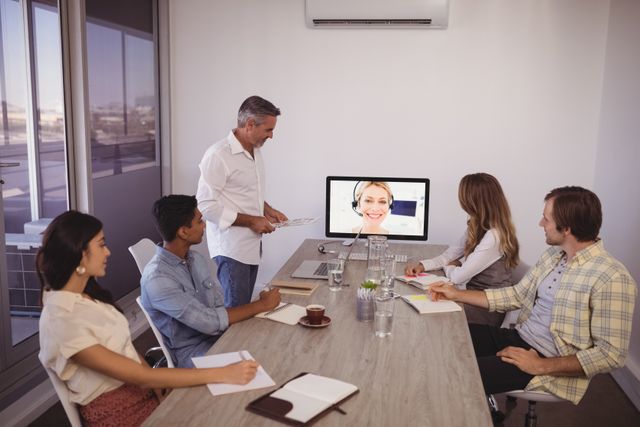 Business people looking at screen during video conference in office - Download Free Stock Photos Pikwizard.com