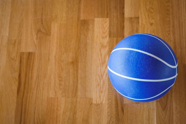 Overhead view of blue basketball on hardwood floor - Download Free Stock Photos Pikwizard.com