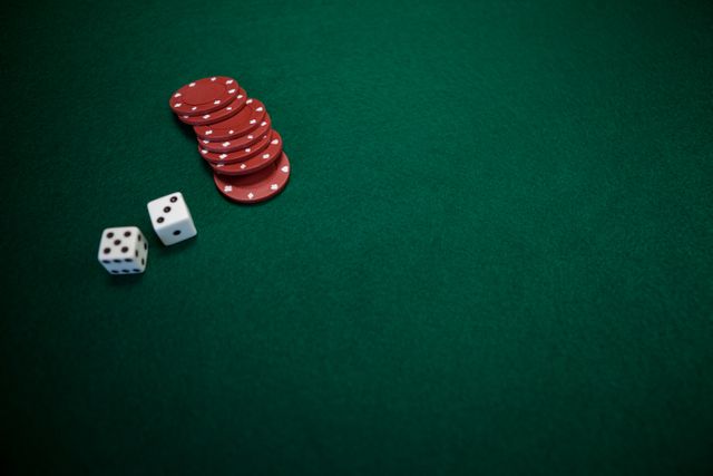 Pair of dice and casino chips on poker table - Download Free Stock Photos Pikwizard.com