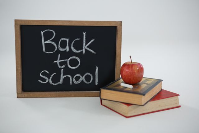 Back to school text with apple and books on white background - Download Free Stock Photos Pikwizard.com