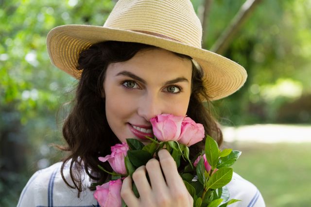 Portrait of woman holding flowers in garden - Download Free Stock Photos Pikwizard.com