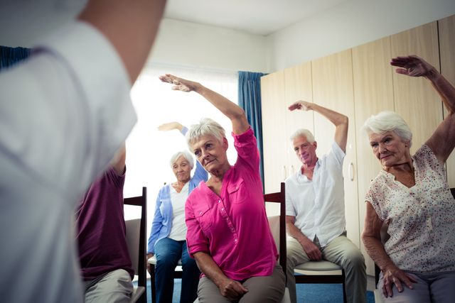 Group of seniors doing exercises with nurse - Download Free Stock Photos Pikwizard.com
