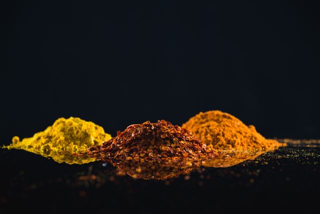 Close-up of powdered spices against black background