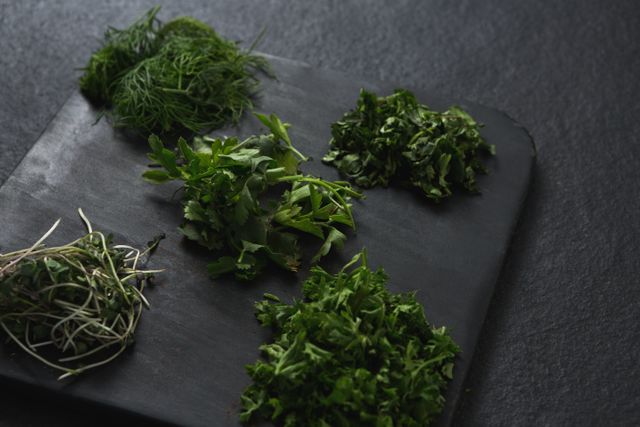 Close-up of various herbs on chopping board