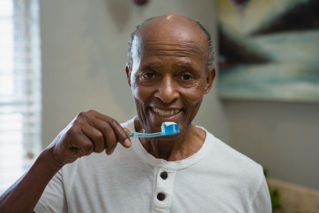Portrait of senior man brushing teeth in bathroom - Download Free Stock Photos Pikwizard.com