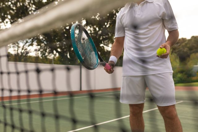 Mid-section of male tennis player holding racket and ball - Download Free Stock Photos Pikwizard.com