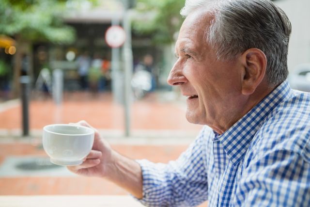 Senior man holding a coffee cup - Download Free Stock Photos Pikwizard.com