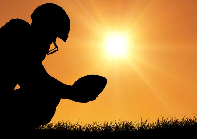 Rugby player holding ball against bright sunlight - Download Free Stock Photos Pikwizard.com