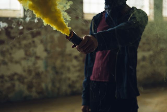 Young man using smoke grenade - Download Free Stock Photos Pikwizard.com