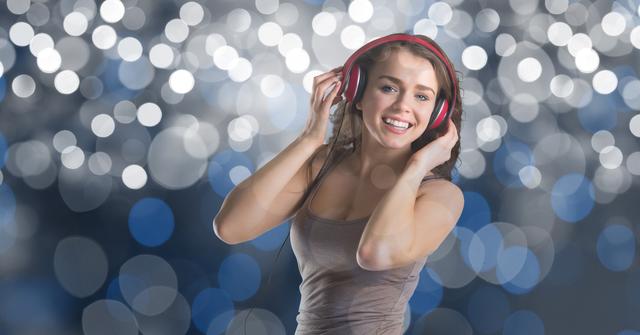 Happy music artist wearing headphones over bokeh - Download Free Stock Photos Pikwizard.com