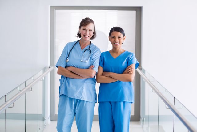 Portrait of smiling nurse and doctor standing with arms crossed - Download Free Stock Photos Pikwizard.com