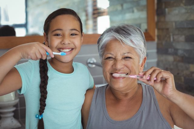 Grandmother and granddaughter brushing teeth in the bathroom - Download Free Stock Photos Pikwizard.com