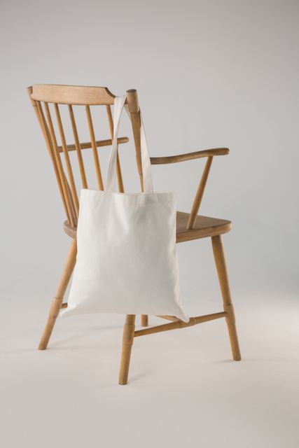 White bag hanging on a wooden chair - Download Free Stock Photos Pikwizard.com