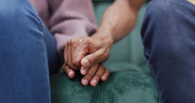 Hands of african american couple sitting on sofa and touching - Download Free Stock Photos Pikwizard.com