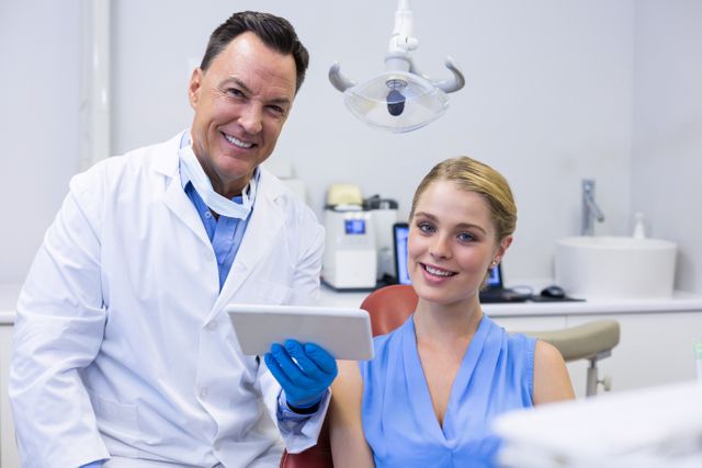 Portrait of smiling dentists and female patient - Download Free Stock Photos Pikwizard.com
