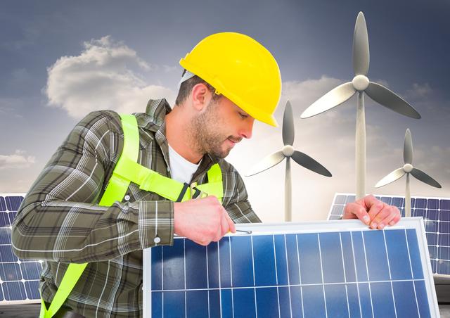 Worker fixing solar panel with wind turbine in background - Download Free Stock Photos Pikwizard.com