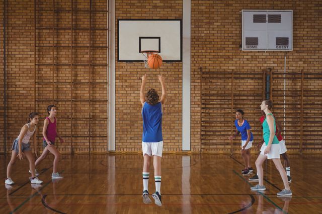 Determined high school kids playing basketball - Download Free Stock Photos Pikwizard.com