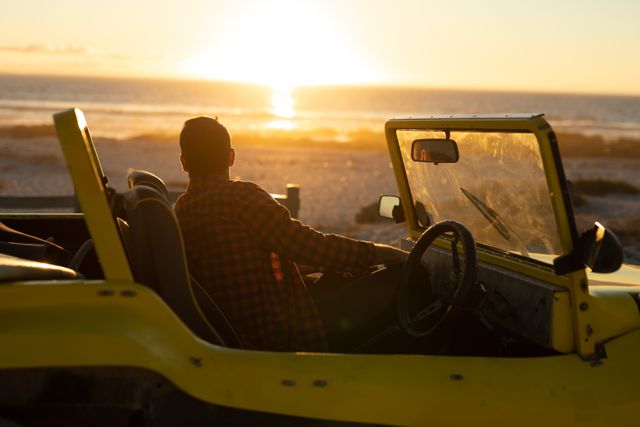 Caucasian man sitting in beach buggy on beach at sunset admiring the view - Download Free Stock Photos Pikwizard.com