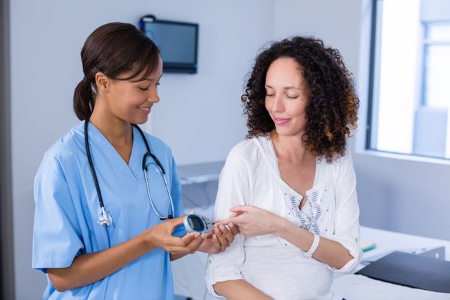 Doctor examining pregnant womans blood sugar - Download Free Stock Photos Pikwizard.com
