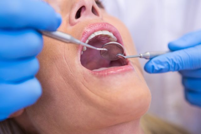 Cropped image of dentist examining patient at medical clinic