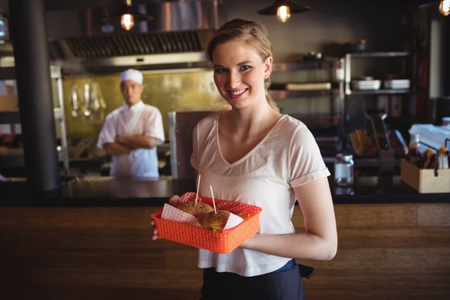 Waitress holding burger in tray - Download Free Stock Photos Pikwizard.com