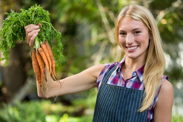 Portrait of beautiful gardener with carrots at garden - Download Free Stock Photos Pikwizard.com