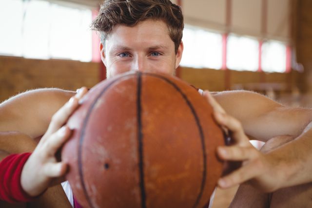 Close up portrait of male basketball player holding ball - Download Free Stock Photos Pikwizard.com