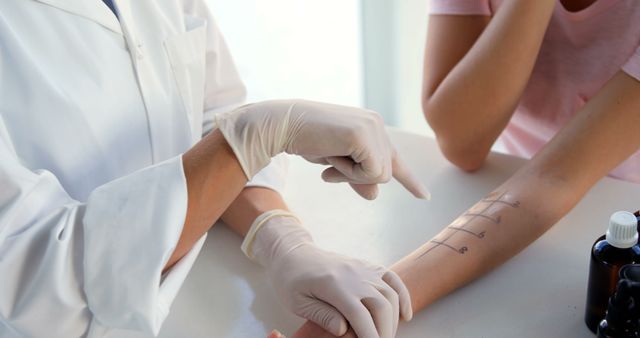 A healthcare professional is performing an allergy test on a patient's arm, with copy space - Download Free Stock Photos Pikwizard.com
