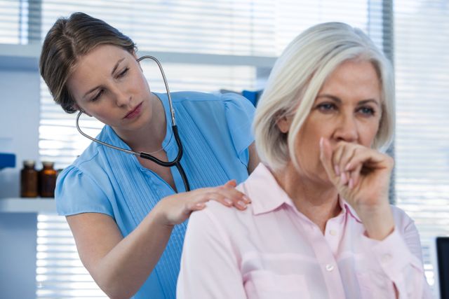 Doctor examining coughing patient - Download Free Stock Photos Pikwizard.com