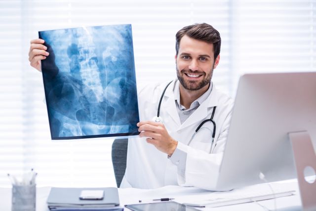 Portrait of male doctor examining x-ray - Download Free Stock Photos Pikwizard.com