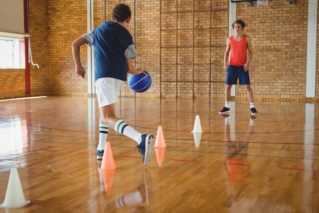 High school boys practicing football using cones for dribbling drill - Download Free Stock Photos Pikwizard.com