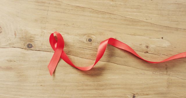Image of red ribbon on wooden background - Download Free Stock Photos Pikwizard.com