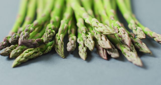 Image of close up of fresh asparagus over grey background - Download Free Stock Photos Pikwizard.com