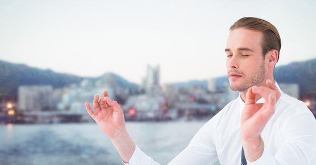 Business man meditating against water and blurry skyline - Download Free Stock Photos Pikwizard.com