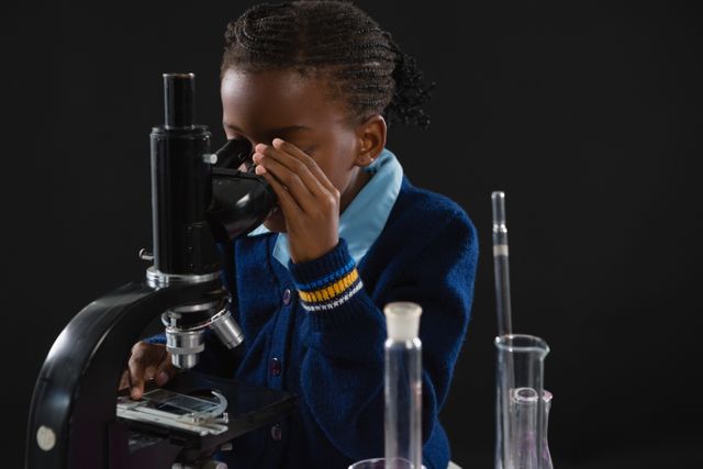 Schoolgirl using microscope - Download Free Stock Photos Pikwizard.com