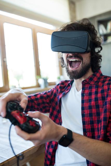 Excited man using virtual reality headset and playing video game - Download Free Stock Photos Pikwizard.com