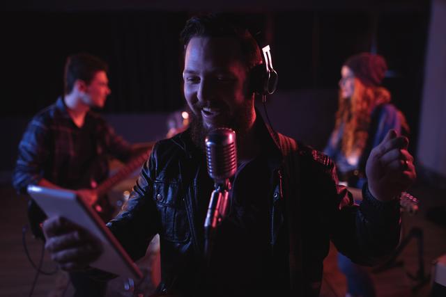 Man singing on retro microphone in recording studio