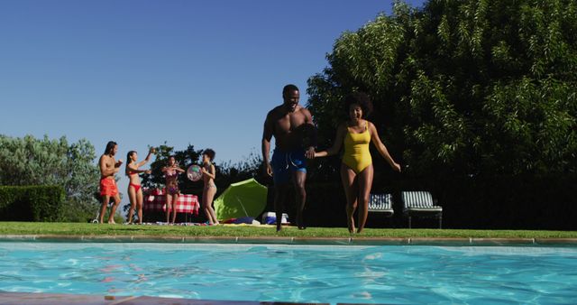 Diverse group of friends having fun jumping into a swimming pool - Download Free Stock Photos Pikwizard.com