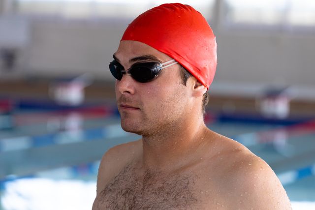 Young male swimmer wearing googles and swimming cap - Download Free Stock Photos Pikwizard.com