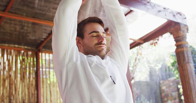 Caucasian man practicing yoga and meditating at vacation home - Download Free Stock Photos Pikwizard.com